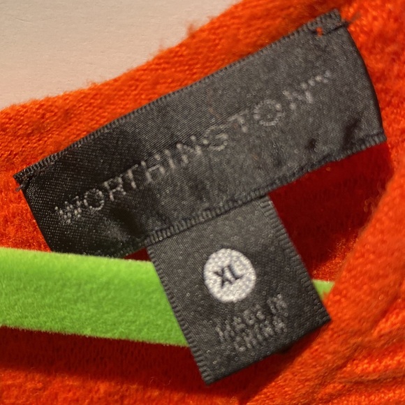 The orange sleeveless top with a peplum finish on the bottom and keyhole bac - Picture 2 of 3